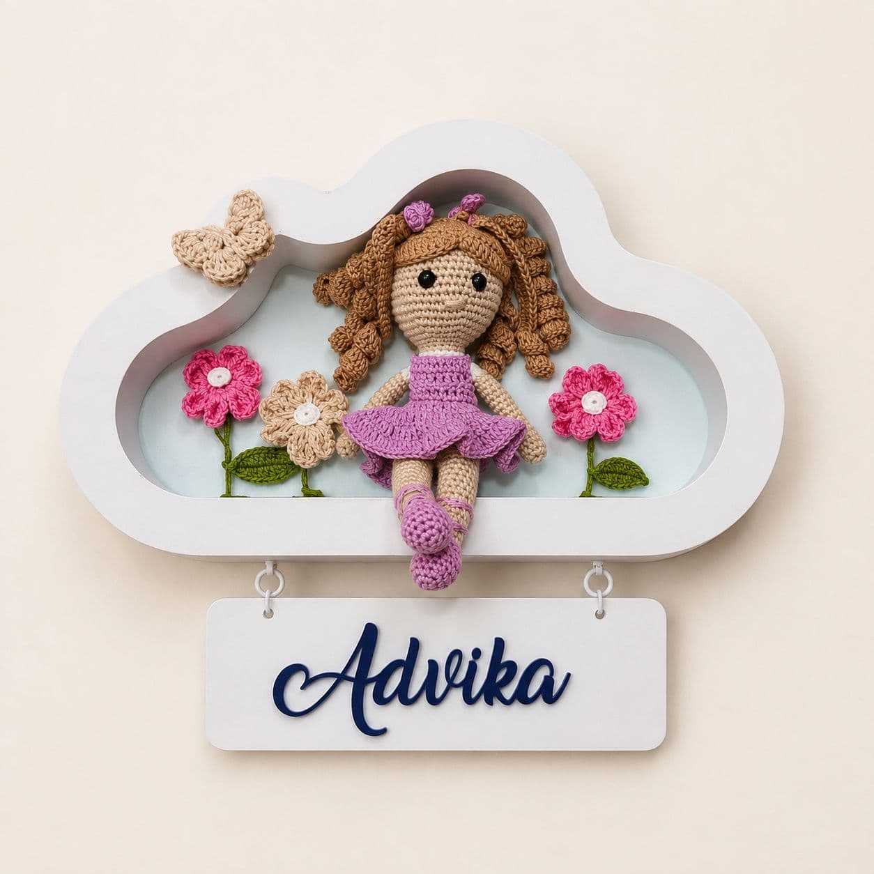 Little Curve cloud frame with a crochet doll and name plaque