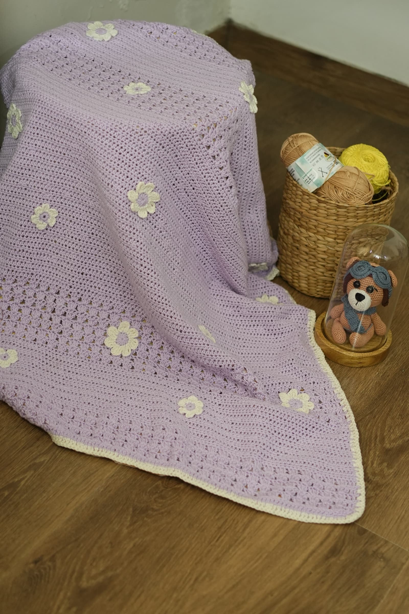 Lavender Bliss lilac crochet blanket with cream daisy appliqués and a cream border